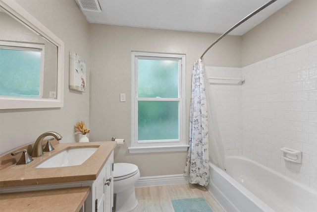 3715 Ember Spring Dr, Kingwood, TX 77339 - full bathroom featuring vanity, plenty of natural light, wood finished floors, and shower / bathtub combination with curtain
