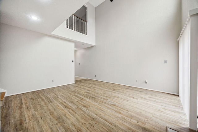 7350 Kirby Dr Unit 46, Houston, TX 77030 - unfurnished living room with wood finished floors and a towering ceiling