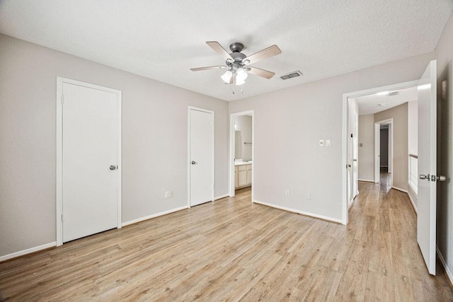 7350 Kirby Dr Unit 46, Houston, TX 77030 - unfurnished bedroom featuring light wood finished floors, ensuite bath, and ceiling fan