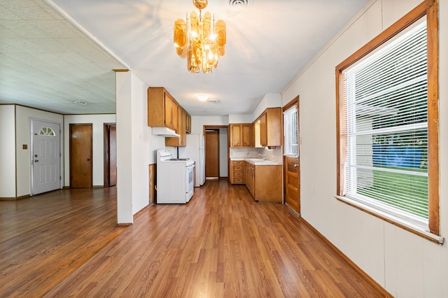 5532 Meadow Creek Ln, Houston, TX 77017 - kitchen featuring white appliances, a chandelier, brown cabinetry, wood finished floors, and light countertops