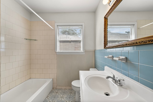 5532 Meadow Creek Ln, Houston, TX 77017 - bathroom with tile patterned flooring, bathing tub / shower combination, vanity, and wainscoting