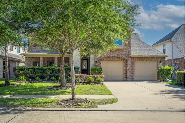 8411 Middle Canyon Rd, Katy, TX 77494 - view of front facade with brick siding, concrete driveway, and a shingled roof