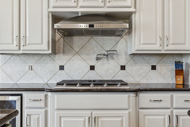 8411 Middle Canyon Rd, Katy, TX 77494 - kitchen with wall chimney exhaust hood, beverage cooler, white cabinetry, stainless steel gas stovetop, and tasteful backsplash
