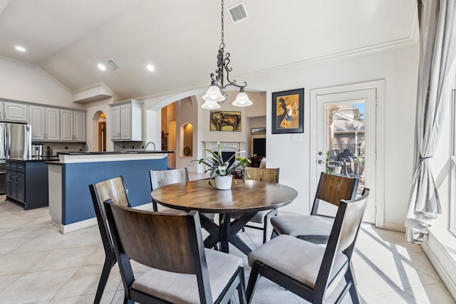 8411 Middle Canyon Rd, Katy, TX 77494 - dining room featuring arched walkways, lofted ceiling, crown molding, and light tile patterned flooring