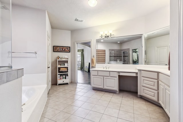 8411 Middle Canyon Rd, Katy, TX 77494 - full bathroom featuring vanity, a shower stall, a bath, tile patterned floors, and a closet