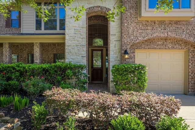 8411 Middle Canyon Rd, Katy, TX 77494 - entrance to property featuring a garage, brick siding, and driveway