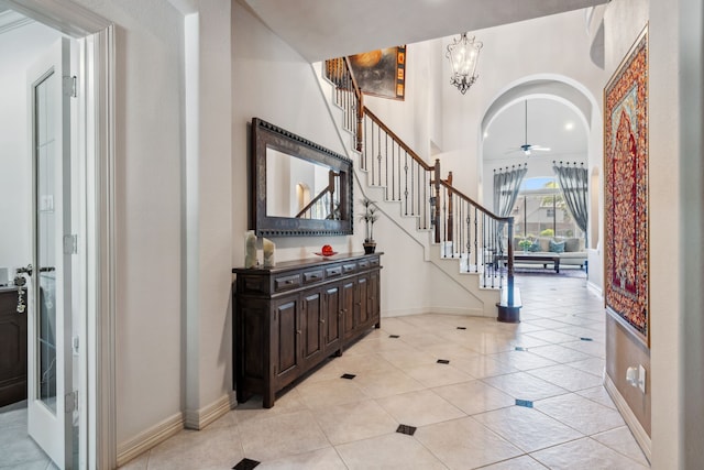8411 Middle Canyon Rd, Katy, TX 77494 - foyer featuring a ceiling fan, stairs, a chandelier, and light tile patterned floors
