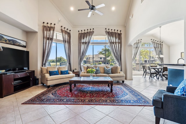 8411 Middle Canyon Rd, Katy, TX 77494 - living room featuring high vaulted ceiling, a ceiling fan, arched walkways, tile patterned floors, and crown molding