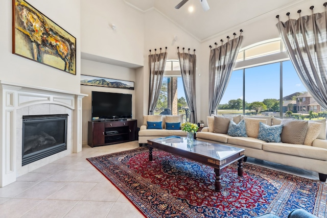 8411 Middle Canyon Rd, Katy, TX 77494 - tiled living area with high vaulted ceiling, ceiling fan, a fireplace, and ornamental molding