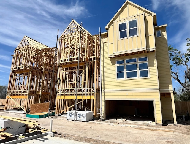 1739 Mary St, Houston, TX 77026 - view of front of house featuring board and batten siding, a garage, and stairs