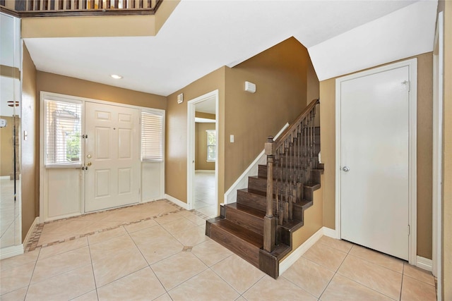 11510 Pagoda Dr, Houston, TX 77477 - entrance foyer with light tile patterned flooring, stairs, and recessed lighting