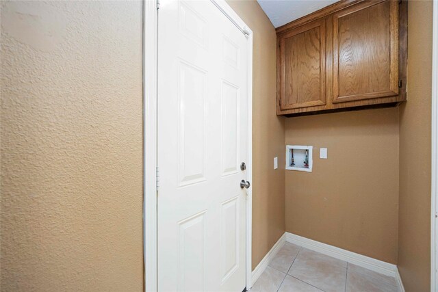 11510 Pagoda Dr, Houston, TX 77477 - washroom with washer hookup, cabinet space, and light tile patterned flooring