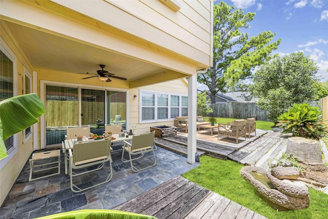 11510 Pagoda Dr, Houston, TX 77477 - deck featuring outdoor dining area, a ceiling fan, and an outdoor living space
