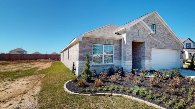 2118 Sanders Brook Dr, Baytown, TX 77521 - view of front of property featuring a garage, driveway, and stone siding