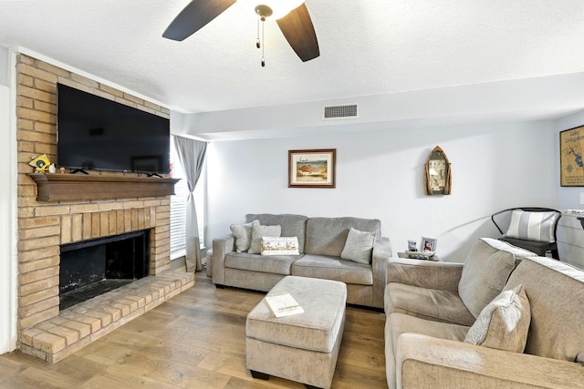 100 Edgewater Dr Unit 39, Livingston, TX 77351 - living room with ceiling fan, wood finished floors, and a fireplace