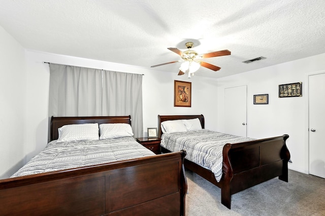 100 Edgewater Dr Unit 39, Livingston, TX 77351 - carpeted bedroom featuring a ceiling fan and a textured ceiling