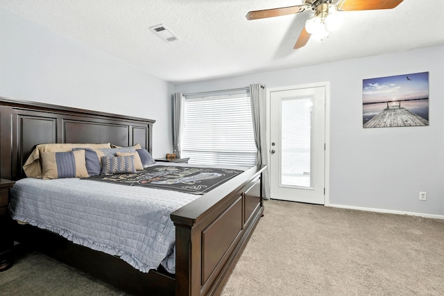 100 Edgewater Dr Unit 39, Livingston, TX 77351 - bedroom with light carpet, a ceiling fan, a textured ceiling, and access to outside