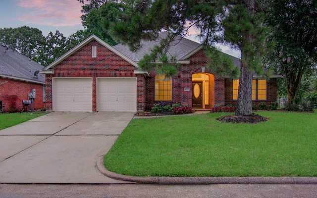 18327 Bluewater Cove Dr, Humble, TX 77346 - view of front of home with brick siding, concrete driveway, a yard, an attached garage, and roof with shingles