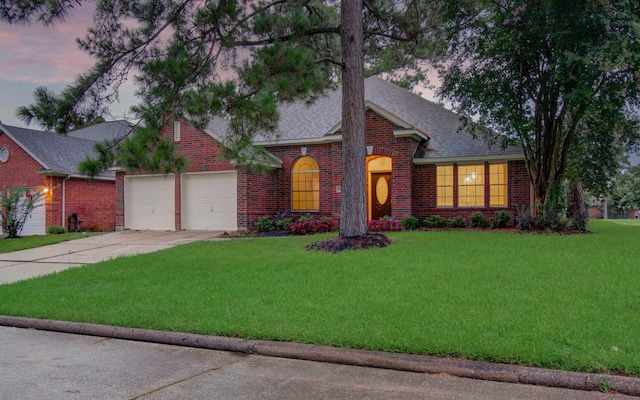 18327 Bluewater Cove Dr, Humble, TX 77346 - view of front of property featuring brick siding, concrete driveway, a lawn, a garage, and a shingled roof