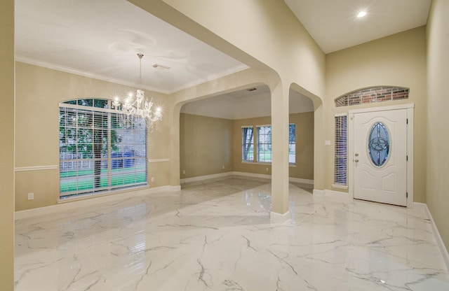 18327 Bluewater Cove Dr, Humble, TX 77346 - foyer entrance featuring arched walkways, marble tiled flooring, a chandelier, and ornamental molding