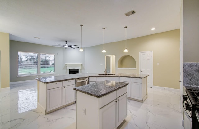 18327 Bluewater Cove Dr, Humble, TX 77346 - kitchen featuring a kitchen island, stove, light marble finish floors, a fireplace, and recessed lighting