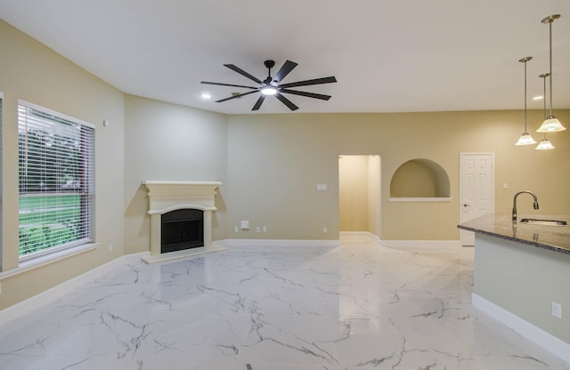 18327 Bluewater Cove Dr, Humble, TX 77346 - unfurnished living room featuring ceiling fan, light marble finish flooring, a fireplace, and recessed lighting