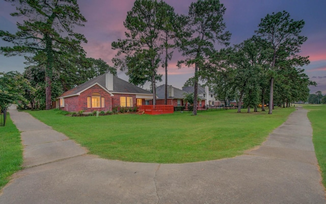 18327 Bluewater Cove Dr, Humble, TX 77346 - view of home's exterior with a yard, a chimney, and brick siding