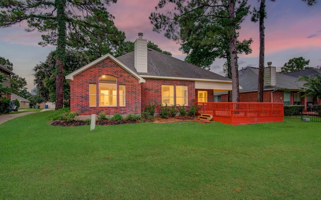 18327 Bluewater Cove Dr, Humble, TX 77346 - view of front of home with brick siding, a chimney, a wooden deck, and roof with shingles