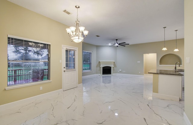 18327 Bluewater Cove Dr, Humble, TX 77346 - unfurnished living room with light marble finish floors, ceiling fan, a chandelier, and a fireplace