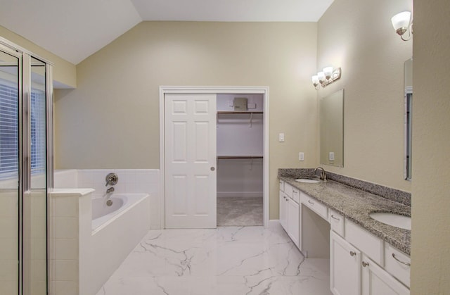 18327 Bluewater Cove Dr, Humble, TX 77346 - full bath featuring double vanity, a garden tub, lofted ceiling, marble finish flooring, and a spacious closet