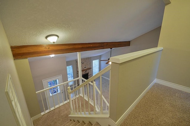 2903 Valley Rose Dr, Kingwood, TX 77339 - hall featuring an upstairs landing, beamed ceiling, and carpet floors