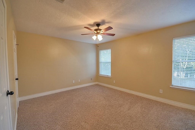 2903 Valley Rose Dr, Kingwood, TX 77339 - unfurnished room featuring ceiling fan, plenty of natural light, light colored carpet, and a textured ceiling