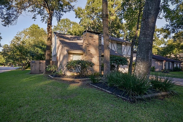 2903 Valley Rose Dr, Kingwood, TX 77339 - view of side of home featuring a chimney and a lawn