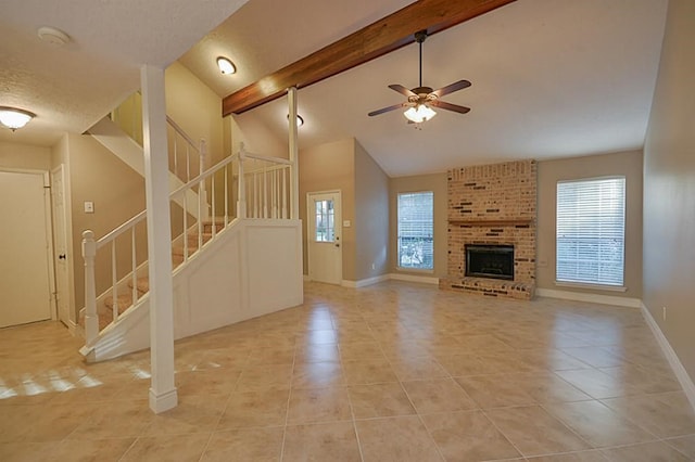 2903 Valley Rose Dr, Kingwood, TX 77339 - unfurnished living room with light tile patterned floors, stairs, beamed ceiling, ceiling fan, and a brick fireplace