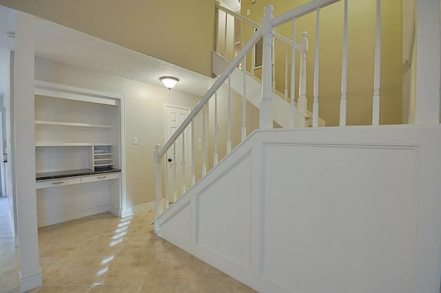 2903 Valley Rose Dr, Kingwood, TX 77339 - stairway with tile patterned flooring and baseboards