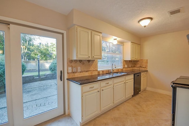 2903 Valley Rose Dr, Kingwood, TX 77339 - kitchen featuring dishwasher, stove, tasteful backsplash, light tile patterned floors, and dark stone counters