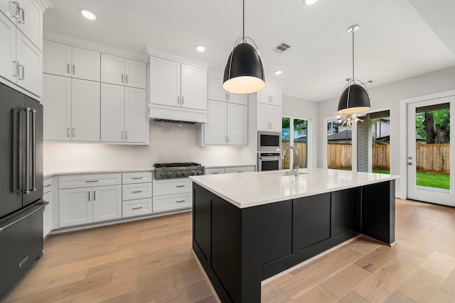 1749 Parana Dr, Houston, TX 77080 - kitchen with appliances with stainless steel finishes, recessed lighting, light countertops, white cabinetry, and premium range hood