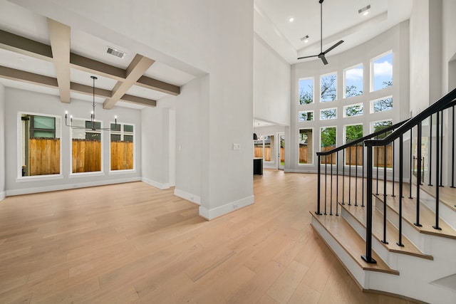 1749 Parana Dr, Houston, TX 77080 - foyer entrance with a ceiling fan, light wood-type flooring, beam ceiling, coffered ceiling, and stairway