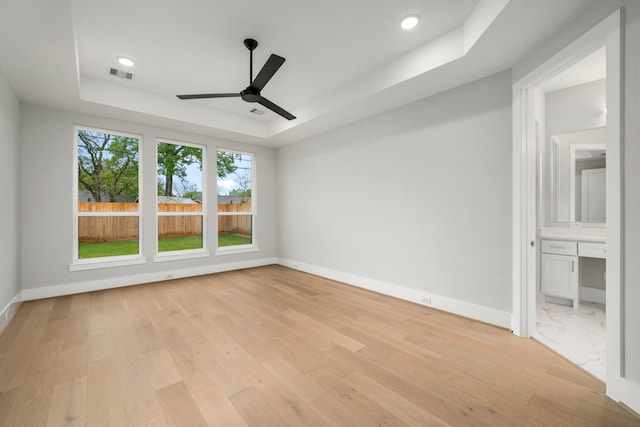 1749 Parana Dr, Houston, TX 77080 - spare room with a raised ceiling, a ceiling fan, light wood-style flooring, and recessed lighting
