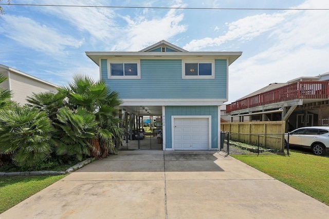 4004 Ector Dr, Galveston, TX 77554 - view of front of property with concrete driveway, a carport, and a garage