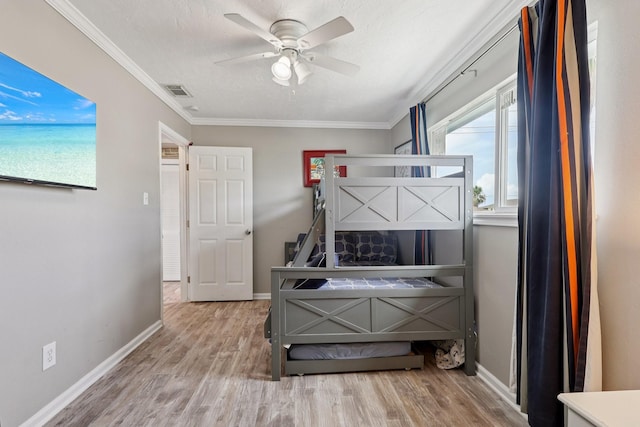 4004 Ector Dr, Galveston, TX 77554 - bedroom with wood finished floors, ornamental molding, a textured ceiling, and a ceiling fan