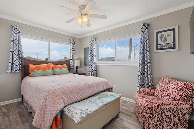 4004 Ector Dr, Galveston, TX 77554 - bedroom featuring multiple windows, wood finished floors, crown molding, and ceiling fan