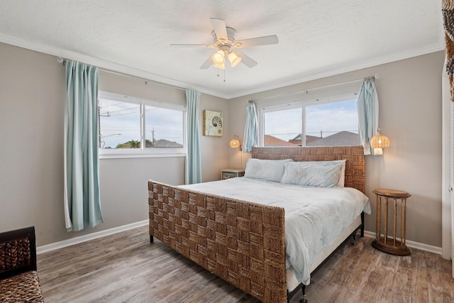 4004 Ector Dr, Galveston, TX 77554 - bedroom featuring wood finished floors, ornamental molding, and a ceiling fan