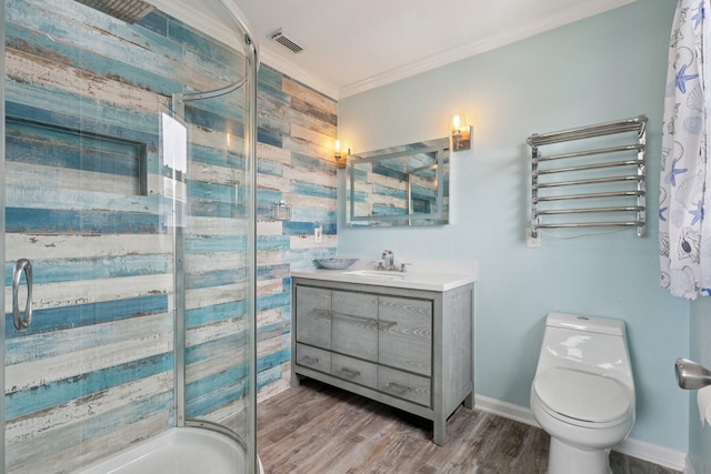 4004 Ector Dr, Galveston, TX 77554 - full bathroom with vanity, crown molding, a towel warmer, wood finished floors, and a stall shower