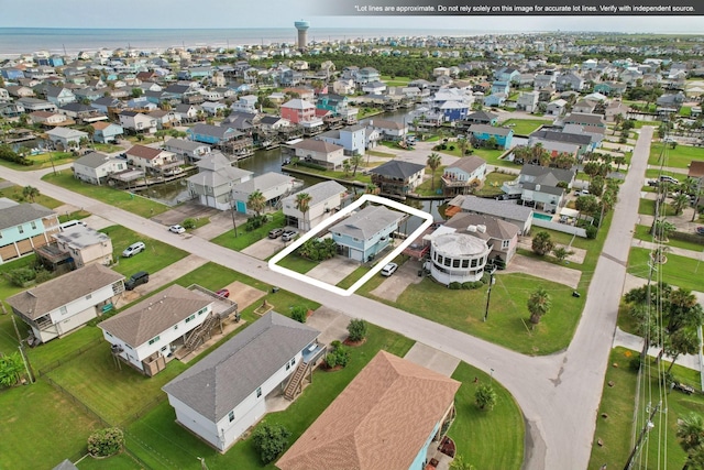 4004 Ector Dr, Galveston, TX 77554 - aerial perspective of suburban area featuring property parcel outlined and a large body of water