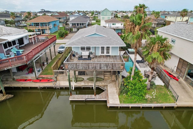 4004 Ector Dr, Galveston, TX 77554 - dock featuring a residential view, a deck with water view, and a fenced backyard