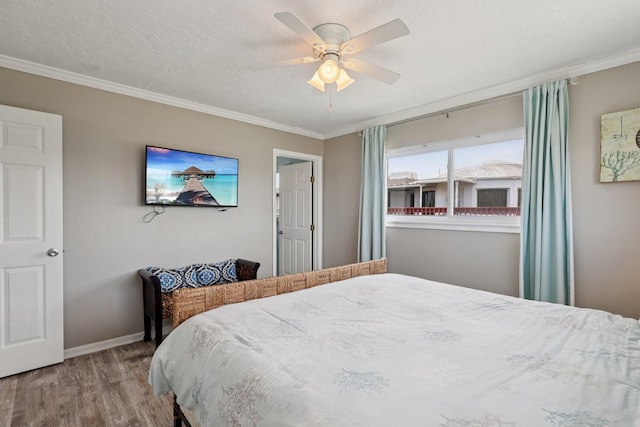 4004 Ector Dr, Galveston, TX 77554 - bedroom with wood finished floors, crown molding, ceiling fan, and a textured ceiling