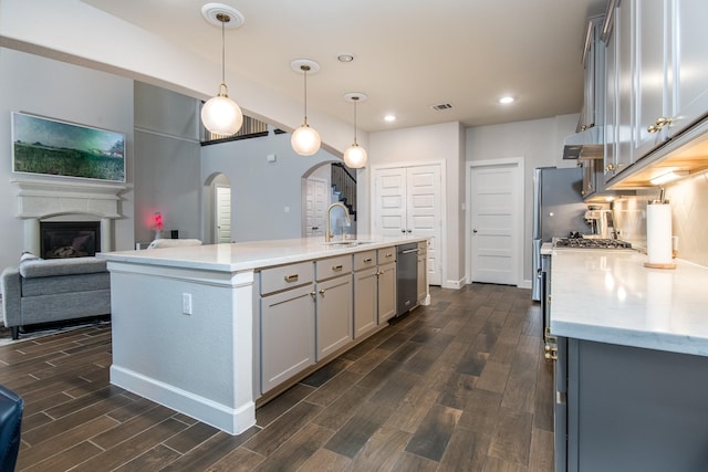 21207 Bradford Grove Dr, Spring, TX 77379 - kitchen with dishwasher, dark wood-style flooring, gray cabinetry, recessed lighting, and an island with sink