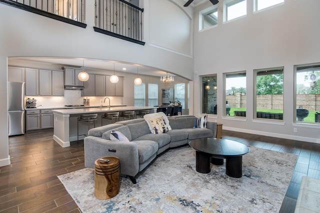 21207 Bradford Grove Dr, Spring, TX 77379 - living room with dark wood-style floors, a high ceiling, ceiling fan, and a chandelier