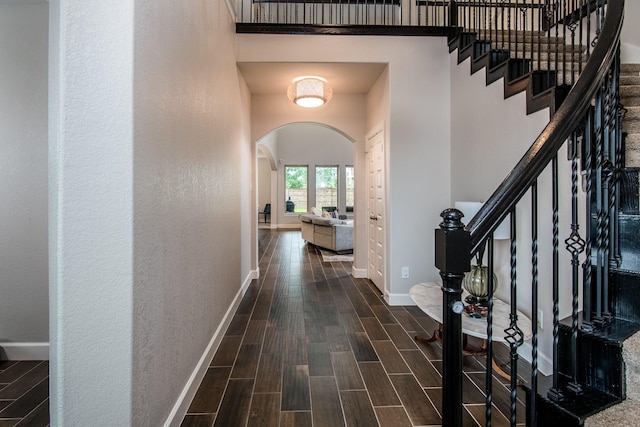 21207 Bradford Grove Dr, Spring, TX 77379 - entrance foyer with arched walkways, dark wood finished floors, and stairs